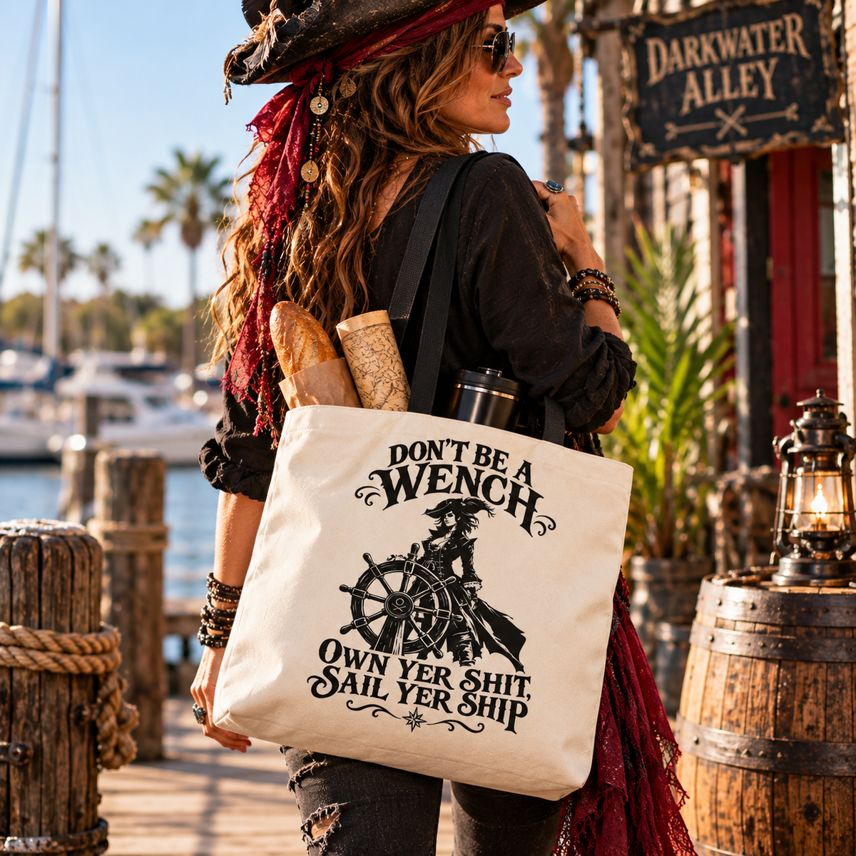 Don't Be A Wench pirate tote bag with a lady pirate captain at the ship's wheel and OWN YER SHIT, SAIL YER SHIP - alternate view