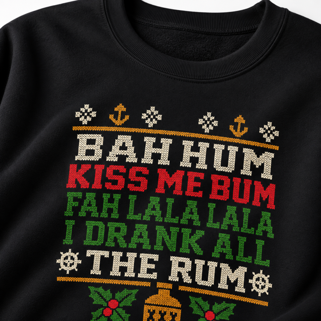 Close-up of the knit-look Bah Hum Kiss Me Bum, I Drank All the Rum lettering on a black sweatshirt