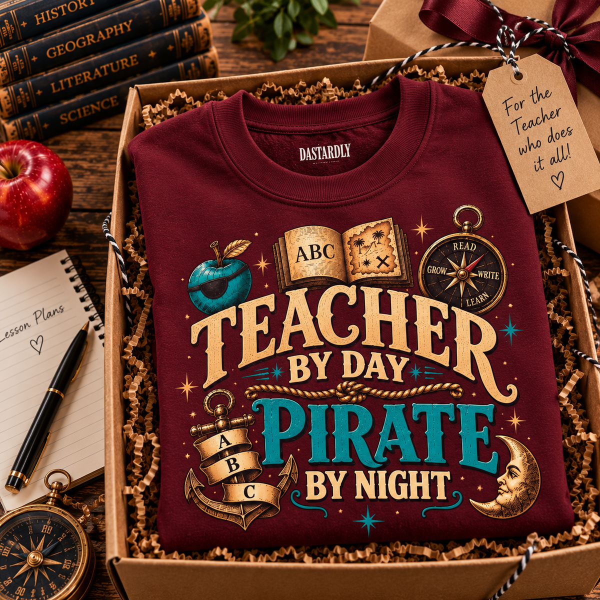 Maroon Teacher by Day Pirate by Night sweatshirt in a gift box with a tag for the teacher who does it all