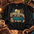 Black Librarian by Day Pirate by Night sweatshirt laid flat with a coffee mug, spyglass and old maps