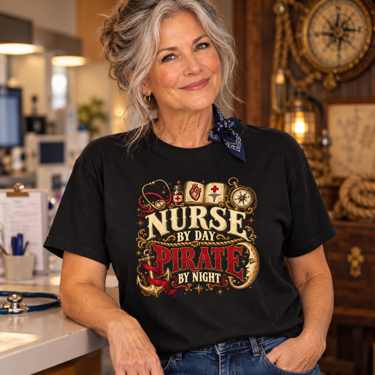 Smiling silver-haired nurse leaning on a hospital counter in a black Nurse by Day Pirate by Night Comfort Colors t-shirt