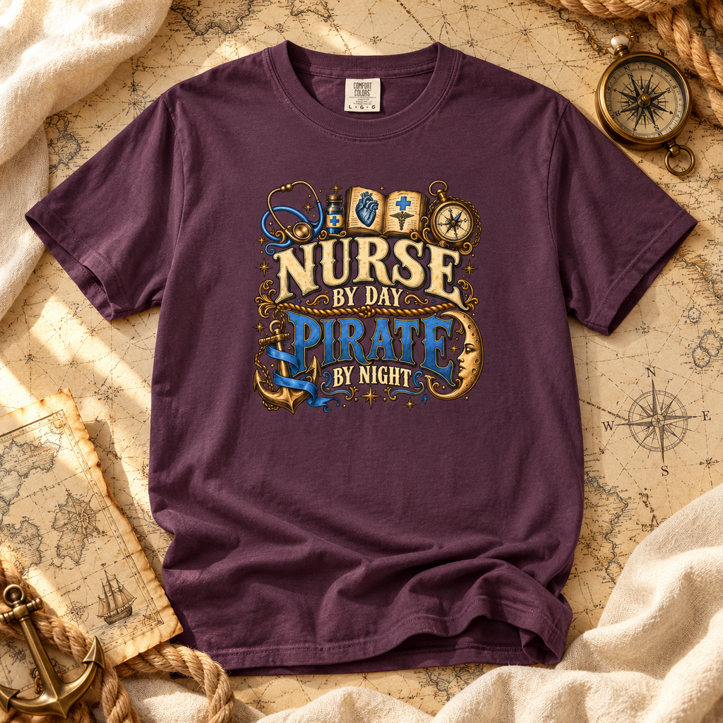 Wine colored Nurse by Day Pirate by Night tee laid flat on an old sea chart with a compass and anchor
